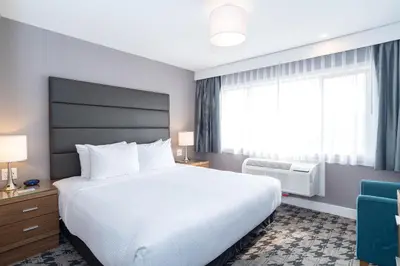 a hotel room with a large bed and a window at Sandman Hotel Edmonton West in Edmonton