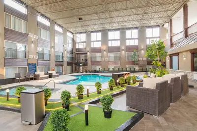 a large building with a pool in the middle at Sandman Hotel Edmonton West in Edmonton