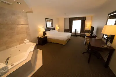 a hotel room with a bed and a bath tub at Holiday Inn Express & Suites Whitecourt by IHG in Whitecourt