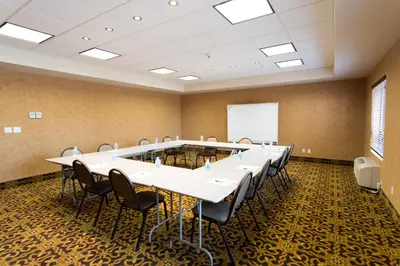 a conference room with a large table and chairs at Holiday Inn Express & Suites Whitecourt by IHG in Whitecourt