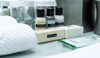 three bottles of essential oils sitting on a table at Executive Plaza Hotel & Conference Centre, Metro Vancouver in Coquitlam