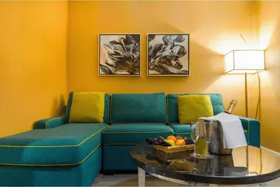 a living room with a blue couch and a table at Executive Plaza Hotel & Conference Centre, Metro Vancouver in Coquitlam