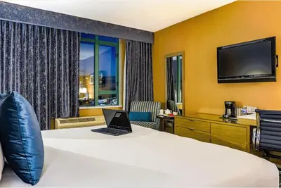 a hotel room with a bed with a laptop on it at Executive Plaza Hotel & Conference Centre, Metro Vancouver in Coquitlam