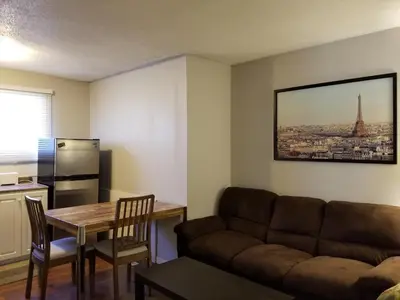 a living room with a couch and a table at Sun Plaza Motel in Sundre