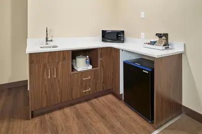 a kitchen with a counter and a sink and a dishwasher at Four Points by Sheraton Sherwood Park in Sherwood Park
