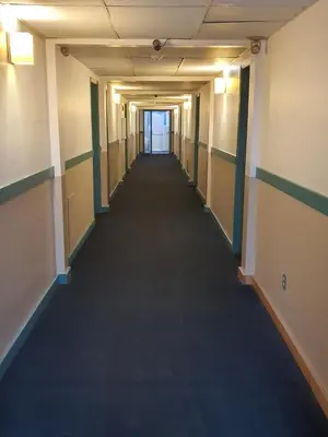 an empty hallway in an office building at Sundre Motor Inn in Sundre