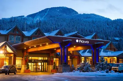 a lodge with a car parked in front of it at Aava Whistler Hotel in Whistler
