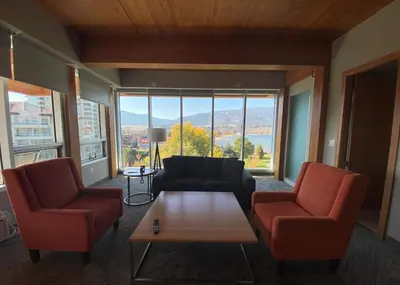 a living room with a couch and two chairs and a table at Penticton Lakeside Resort in Penticton