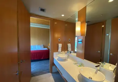 a bathroom with two sinks and a large mirror at Penticton Lakeside Resort in Penticton
