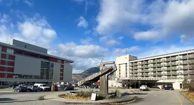 a city with a building and a street with cars at Penticton Lakeside Resort in Penticton