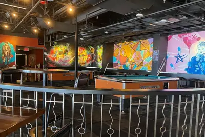 a dining room with tables and ping pong tables at Penticton Lakeside Resort in Penticton