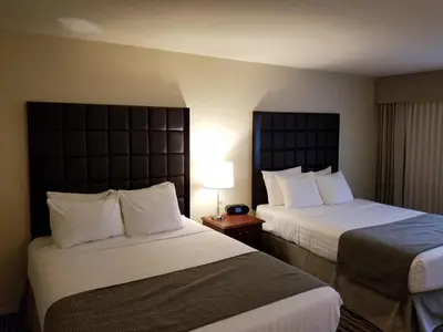 a hotel room with two beds and a window at Prestige Vernon Lodge in Vernon