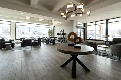 a lobby with chairs and a table in a building at Prestige Vernon Lodge in Vernon