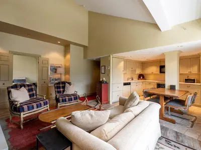 a living room with a couch and a table at Gibbons Life Accommodations in Whistler