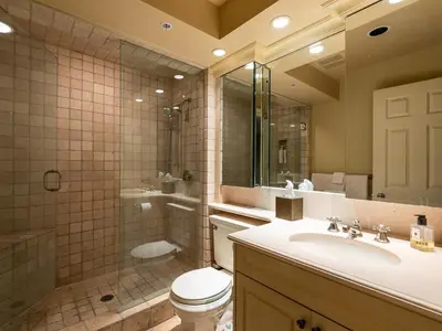 a bathroom with a toilet and a sink and a shower at Gibbons Life Accommodations in Whistler