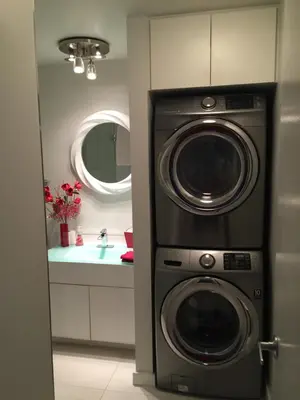 a bathroom with a washing machine and a sink at A Room at the Camelia Bed and Breakfast in Tsawwassen