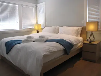 a bedroom with a bed with two towels on it at Riverfront Bed and Breakfast in North Vancouver