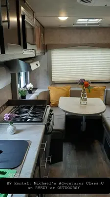 a kitchen with a stove and a table in a room at Riverfront Bed and Breakfast in North Vancouver