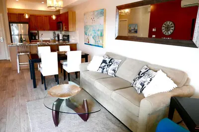 a living room with a couch and a table at Copper Oasis in West Kelowna