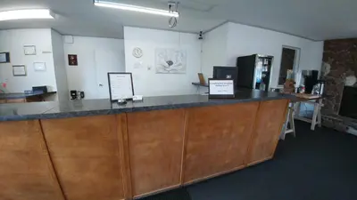 an office with a counter with signs on it at Howard Johnson by Wyndham Edson in Edson