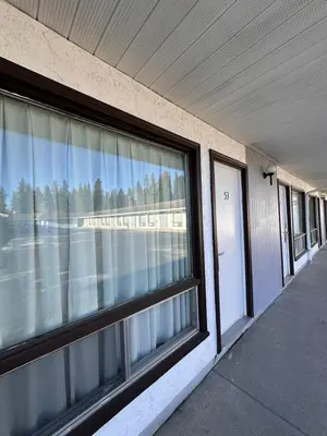 an empty building with a window and a door at Howard Johnson by Wyndham Edson in Edson