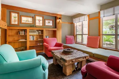 a living room with colorful chairs and a table at Hilton Grand Vacations Club Whistler in Whistler
