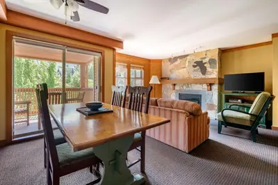 a living room with a table and a couch at Hilton Grand Vacations Club Whistler in Whistler
