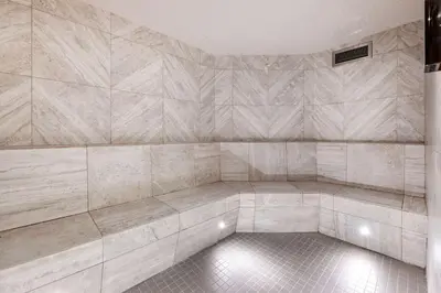 an empty room with a tiled wall with aitating at Hilton Grand Vacations Club Whistler in Whistler