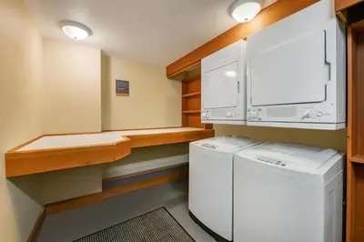 a small laundry room with a washer and dryer at Hilton Grand Vacations Club Whistler in Whistler