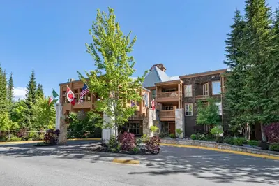 a house on a street with a tree at Hilton Grand Vacations Club Whistler in Whistler