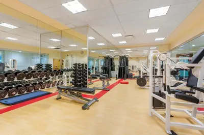 a gym with a lot of equipment in a room at Embarc Vancouver in Vancouver