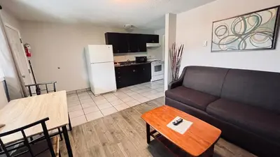 a living room with a couch and a table at Maple Leaf Motel & RV Park Resort in Oliver