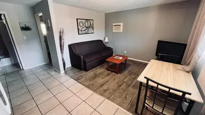 a living room with a couch and a table at Maple Leaf Motel & RV Park Resort in Oliver