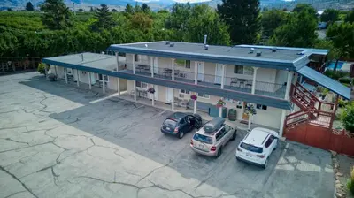 an overhead view of a building with cars parked in a parking lot at Maple Leaf Motel & RV Park Resort in Oliver