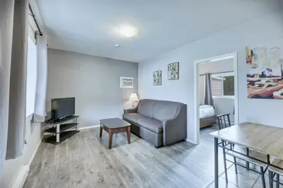 a living room with a couch and a television at Maple Leaf Motel & RV Park Resort in Oliver