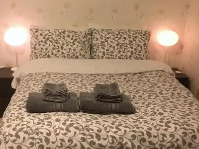 a bedroom with a bed with two towels on it at Vancouver Homestay Inn in Richmond