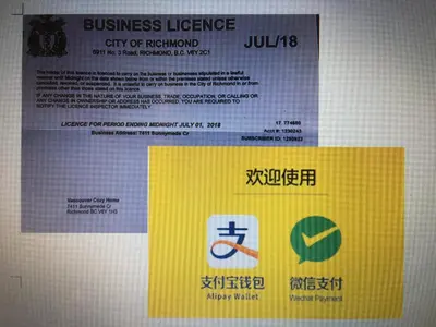 a sign on a wall with a business license at Vancouver Homestay Inn in Richmond