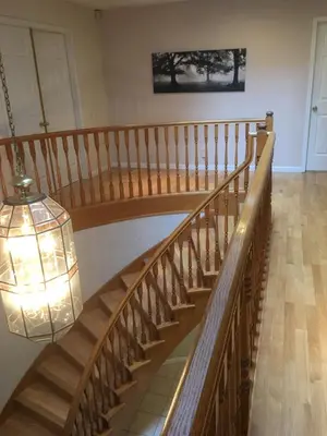 a staircase in a building with a chandelier at Vancouver Homestay Inn in Richmond