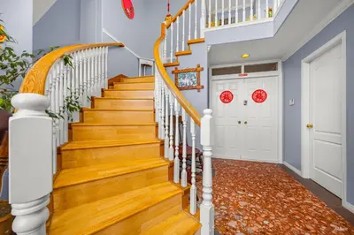 a staircase in a home with wood floors and white railings at Charming Family Hotel in Richmond