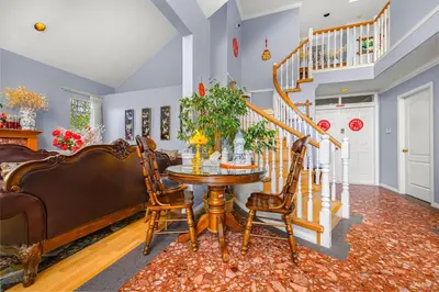 a dining room with a table and chairs and a staircase at Charming Family Hotel in Richmond