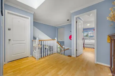 a hallway with blue walls and a white door at Charming Family Hotel in Richmond