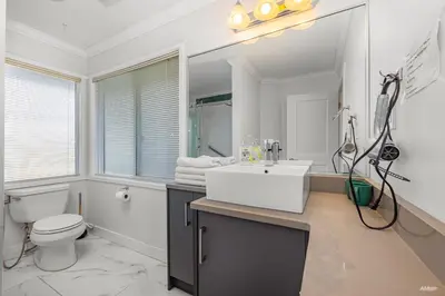 a white bathroom with a sink and a toilet at Charming Family Hotel in Richmond