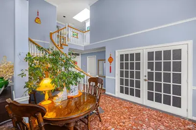 a dining room with a table and chairs and a staircase at Charming Family Hotel in Richmond
