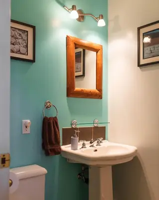 a bathroom with a sink and a mirror on the wall at Cloudside Hotel in Nelson