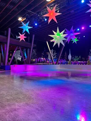 a ice skating rink with colorful stars hanging from the ceiling at Mountainview 1 bedroom suite with check in services king size bed walk to Village WIFI cable TV free parking boot and glove warmer in Pemberton