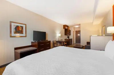 a hotel room with a bed and a television at Best Western Plus Chateau Fort St. John in Fort Saint John