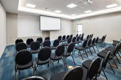 a conference room with chairs and a projection screen at Holiday Inn Express - Red Deer North by IHG in Red Deer