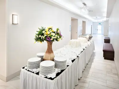 a long white table with plates and flowers on it at Holiday Inn Express - Red Deer North by IHG in Red Deer