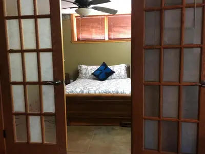 a door with a bench with a blue pillow on it at Mistiso's Place in Nelson