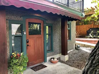 a house with a wooden door and a porch at Mistiso's Place in Nelson